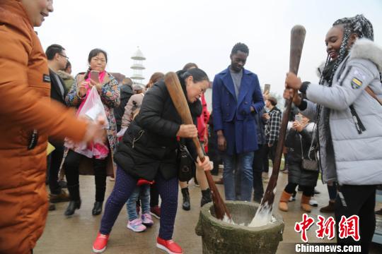 图为留学生体验打糍粑的乐趣。　杨孝勇 摄